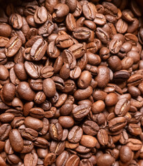 Close up of roasted coffee beans with rich brown texture and aromatic detail