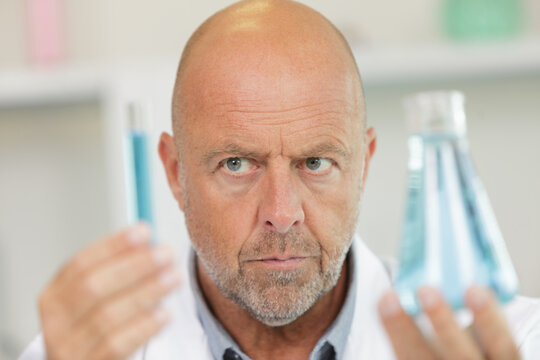 senior male researcher carrying out scientific research in a lab