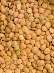 Close up of dry brown lentils in a pile as background texture