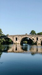 Fototapeta premium Ancient stone bridge over river