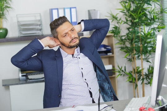 portrait of businessman stretching in office