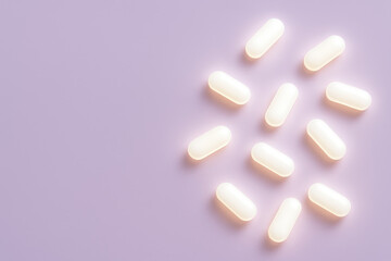 Pharmaceuticals and Well-being: A cluster of pristine white pills, meticulously arranged on a pastel surface, embody the promise of health, healing, and wellness in this striking image.