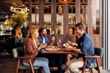 Group of Friends Enjoying a Meal Together in a Stylish Restaurant