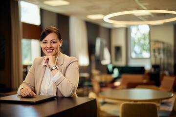 Confident Businesswoman in a Modern Office Setting Working with a Laptop