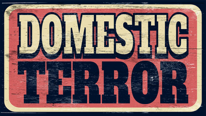 Aged and worn domestic terror sign on wood