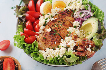 A bowl with cobb salad, traditional American dish	