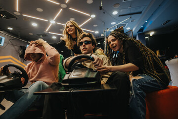 Group of friends having fun racing on simulators in a modern gaming lounge, sharing laughter and enjoying friendly competition during an engaging and spirited gaming experience.