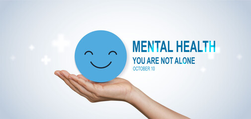 World Mental Health Day concept with hands holding happy smile face symbol, promoting support, awareness, positivity and emotional wellbeing, you are not alone.