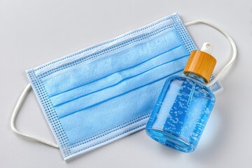 Essential hygiene items featuring protective face mask and hand sanitizer bottle conveying the importance of health safety in contemporary society enhancing daily wellness practices