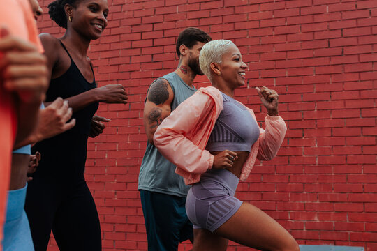 Group of athletes running together in an urban setting in lisbon - Powered by Adobe