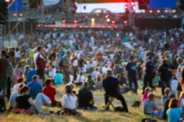 Blurred background of vibrant outdoor music festival