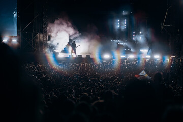 Crowd at concert and blurred stage lights.