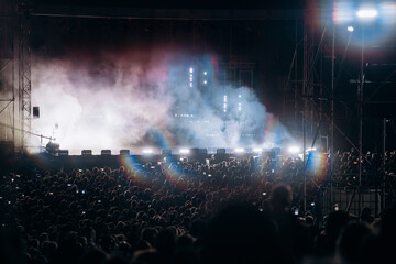 Crowd at concert and blurred stage lights.
