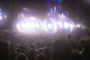 Crowd at concert and blurred stage lights.