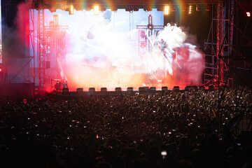 Crowd at concert and blurred stage lights.