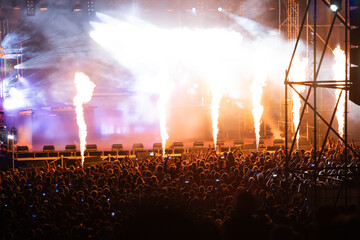 Crowd at concert and blurred stage lights.