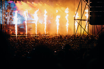 Crowd at concert and blurred stage lights.