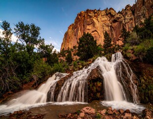 Obraz premium Scenic waterfall cascading down rocks