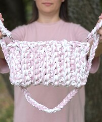 pink and white knitted bag made of knitted yarn