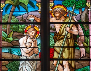 Stained glass (1920) of Baptism of Jesus by John the Baptist in the Jordan river.