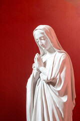 Statue (19th century) of Virgin Mary at prayer.