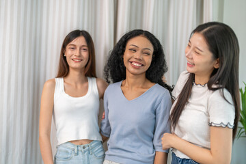 Diverse group of women friends smiling and talking together, happy female friendship bonding joyful conversation and connection, empowerment support, trust and love, laughter positivity at home