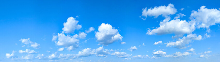 Wide detailed panorama of the sky with a large number of clouds. Spacious summer clear space with cloud flying towards the wind. Uniform filling with white spots of diagonal movement
