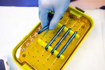 close-up of dentist hand with dental tools