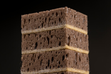brown sponge with lots of holes for good foaming of detergents and is used for cleaning, brown sponge for washing dirty dishes