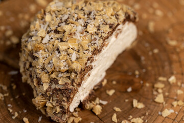 one cut marshmallows sprinkled with crumbs, sweet dessert marshmallows in milk chocolate with crumbs cut in half