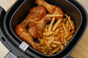 Air-fried chicken drumsticks and thin, crispy, golden fries