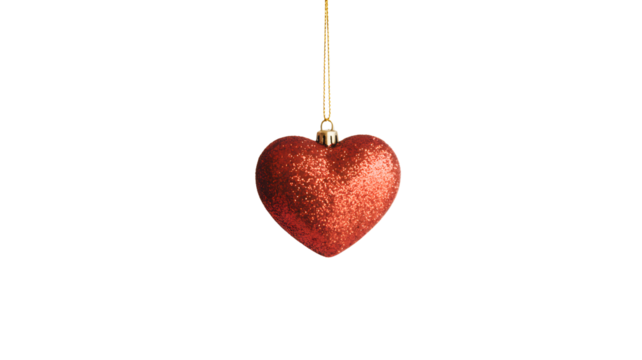 A single sparkling red heart shaped christmas ornament hanging from a thin string isolated on transparent background