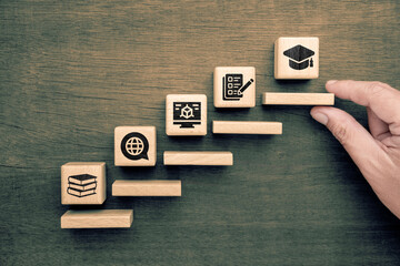 Wooden blocks arranged as educational steps with icons representing reading, internet research,...