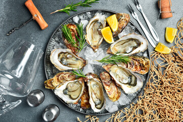 Dinner in restaurant. Wine glasses and oysters on a plate. Healthy sea food. Gourmet food, side view.