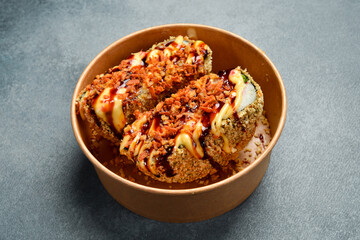 Sushi burger with fish, avocado and cheese. Japanese cuisine. Food delivery. Close-up.