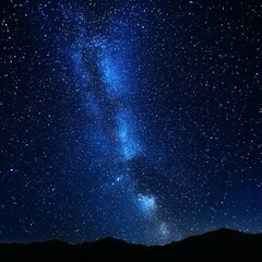 Obraz premium Stunning night sky filled with stars and milky way over mountain silhouette