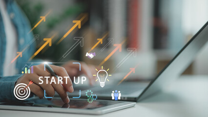 Hand using tablet with virtual startup and growth icons, symbolizing business innovation, entrepreneurship, idea development, strategy planning, and successful company launch in the digital economy