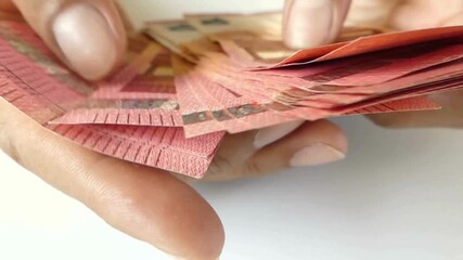 male hands of a businessman and trader counting ten euro banknotes, closeup. Holding and counting a stack of 10 banknotes in hands. close up video of a Person counting ten euro banknote money. - Powered by Adobe