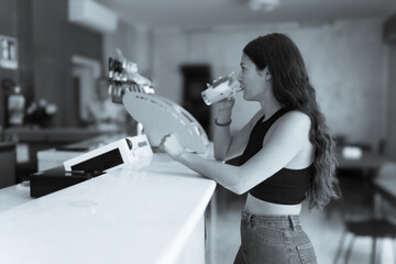 Serene Summertime Morning Young Woman Sips Refreshing Latte Macchiato While Relaxing at a Lively...
