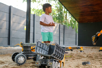 child playing in the sand excavator