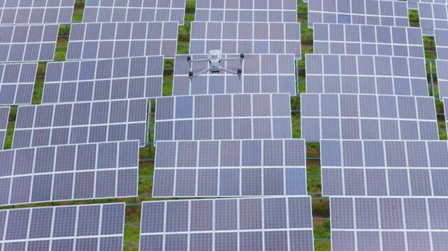 DJI Matrice 4T drone flying over large solar farm. Aerial view