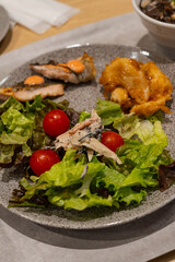 a heartily vegetable salad with mayonnaise and fish flakes dressing 