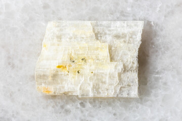 sample of rough eudidymite mineral on white marble