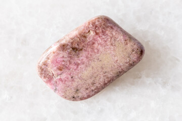 sample of polished pyroxmangite mineral on white