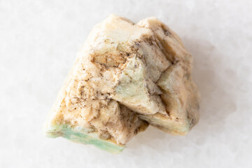 sample of raw amazonite mineral on white marbl