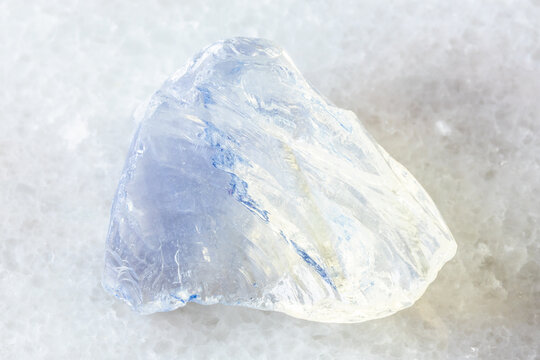 sample of rough molybdenum glass on white marble