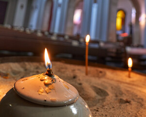 Candles on the sand in a church