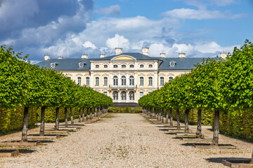 Rundale Palace - Baroque architecture with tree lined alley in the formal gardens, Latvia