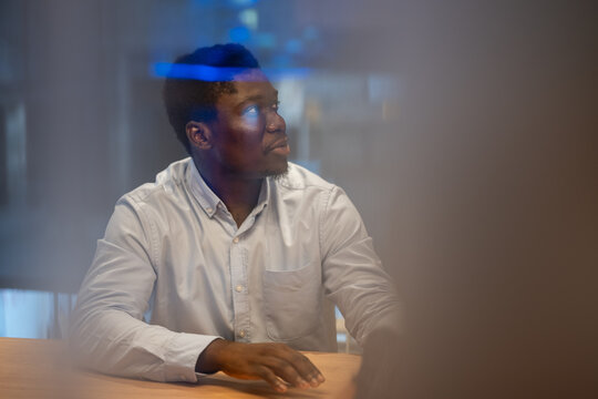 Thoughtful african american man in business shirt at modern office meeting