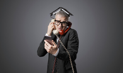 Stressed businessman answering phone calls